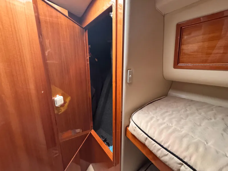 Slide: The Image of Interior cabin of 2005 Riviera 40 Flybridge with wooden closet and bed. - 24