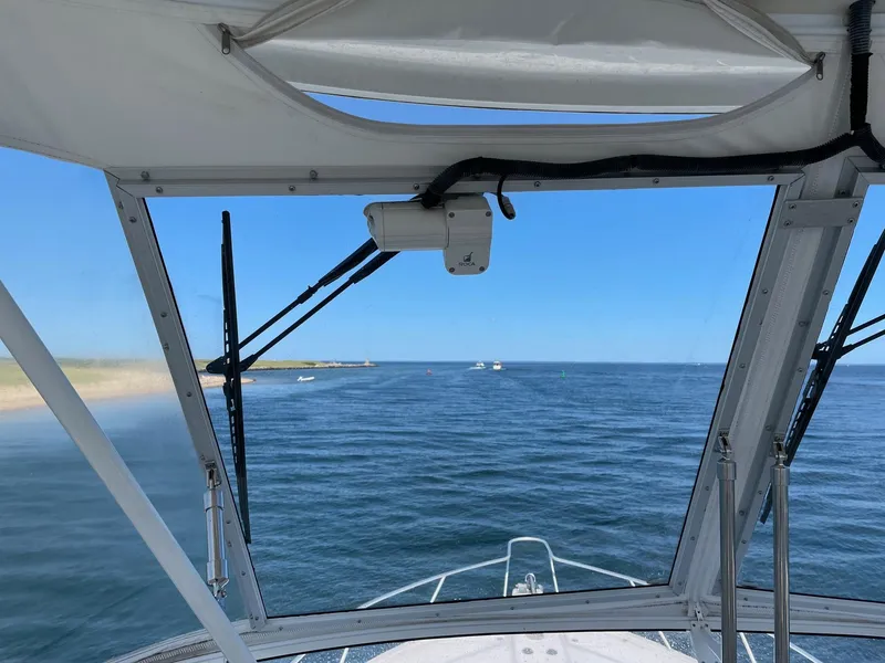 Slide: The Image of View from 2005 Riviera 40 Flybridge, looking out to open sea under clear blue skies. - 29