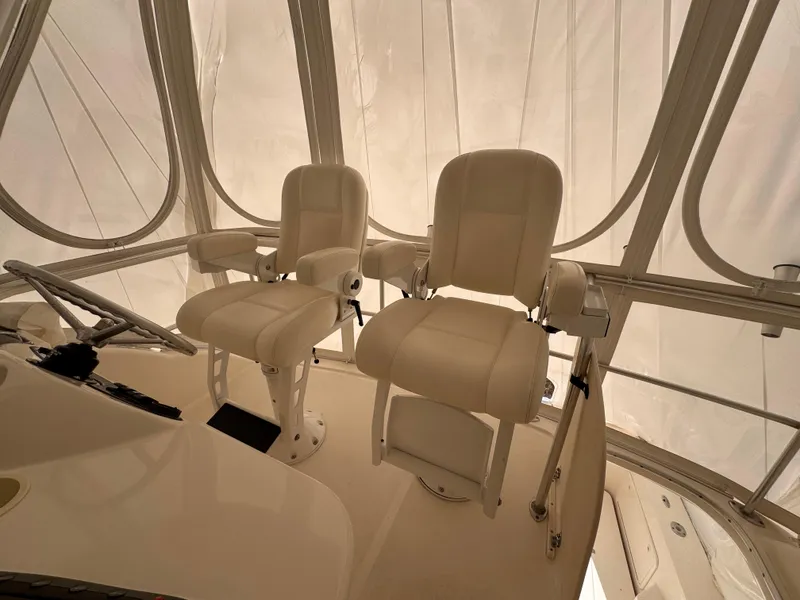 Slide: The Image of 2005 Riviera 40 Flybridge interior with two white captain chairs. - 32