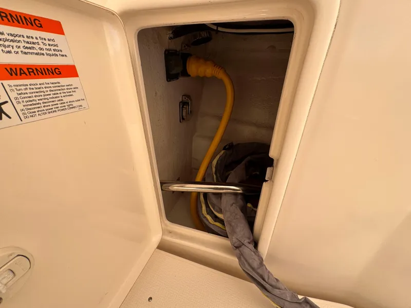 Slide: The Image of 2005 Riviera 40 Flybridge electrical compartment with yellow power cable and warning label. - 40