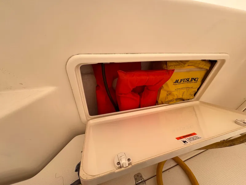 Slide: The Image of Storage compartment on 2005 Riviera 40 Flybridge with life jackets and safety equipment. - 41