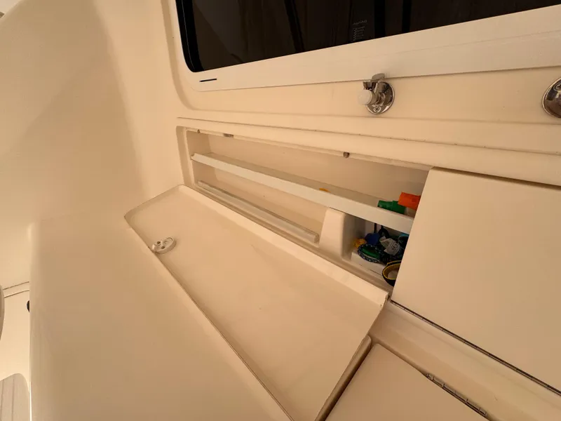 Slide: The Image of 2005 Riviera 40 Flybridge interior storage compartment with open sliding doors. - 48