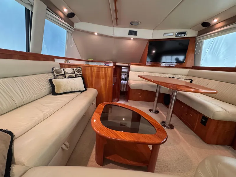 Slide: The Image of Luxurious interior of 2005 Riviera 40 Flybridge yacht with elegant seating and wooden accents. - 5