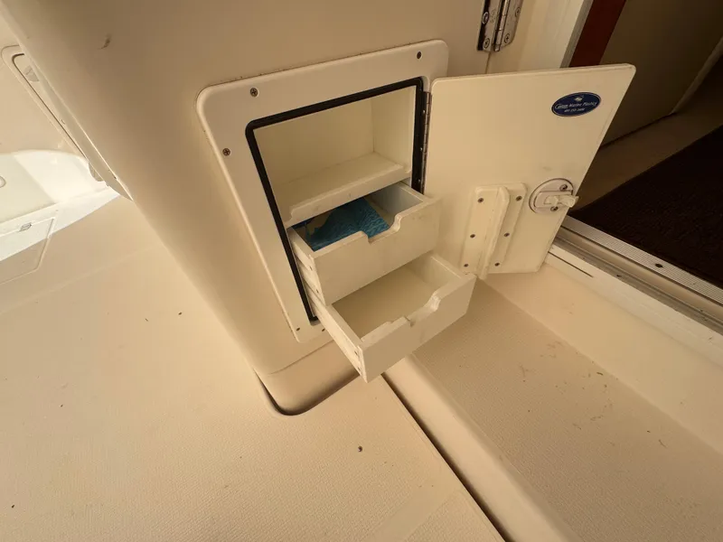 Slide: The Image of Storage compartment on 2005 Riviera 40 Flybridge boat, open with visible shelves. - 53