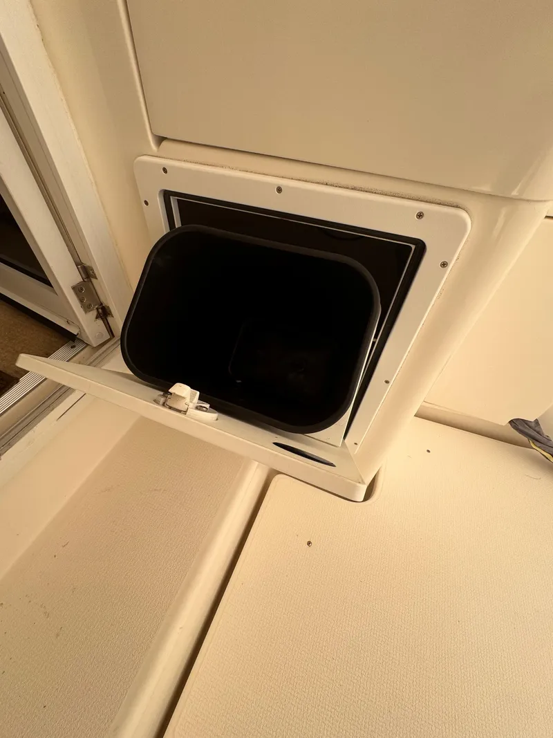 Slide: The Image of Open hatch on 2005 Riviera 40 Flybridge boat, showing interior compartment. - 54