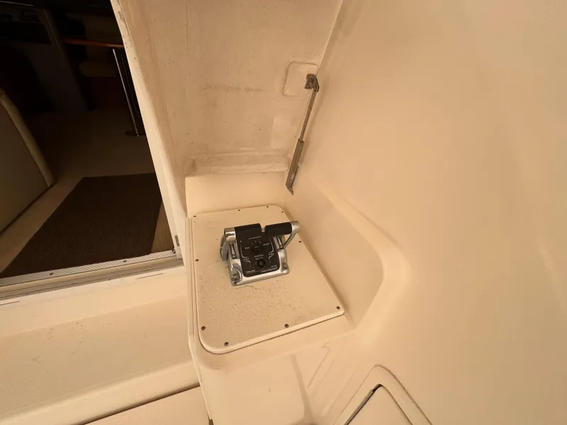 Slide: The Image of Riviera 40 Flybridge 2005 interior detail, showcasing a control panel and seating area. - 55