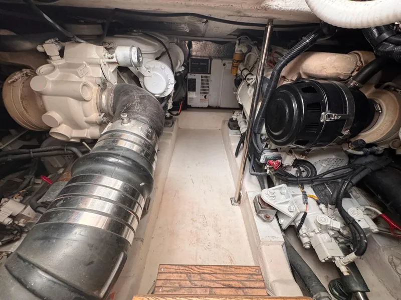 Slide: The Image of Engine room of a 2005 Riviera 40 Flybridge yacht, showcasing mechanical components. - 59