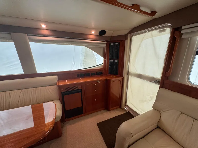 Slide: The Image of Interior of 2005 Riviera 40 Flybridge yacht with seating and wooden cabinetry. - 8
