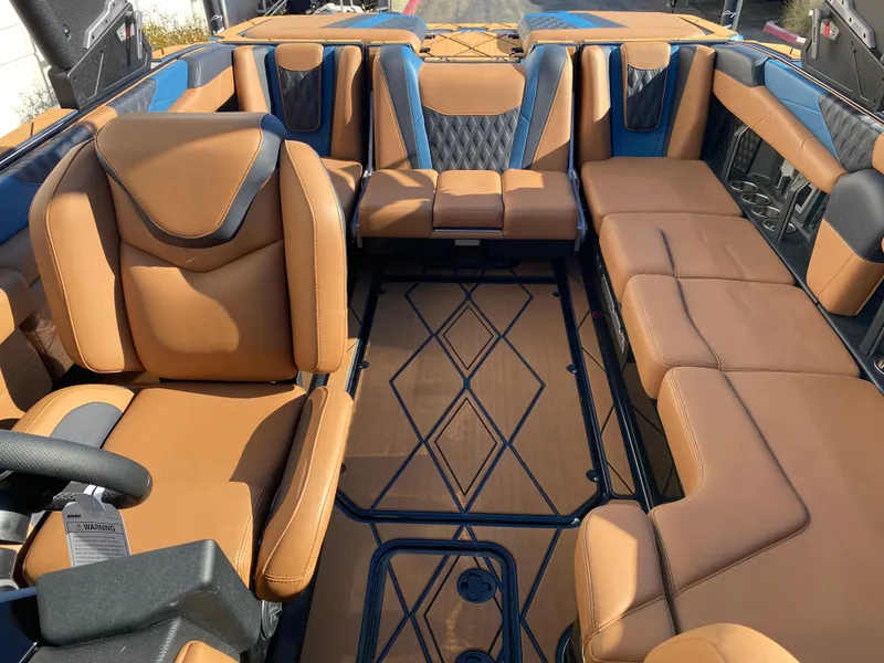 Slide: The Image of 2025 Malibu M230 boat interior with luxurious tan leather seating and modern design. - 8