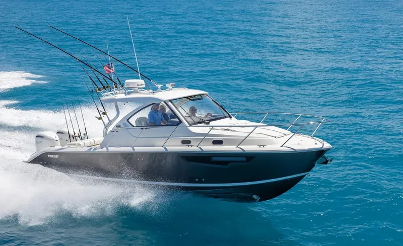 Slide: The Image of 2025 Pursuit OS 325 boat cruising on clear blue ocean waters. - 1