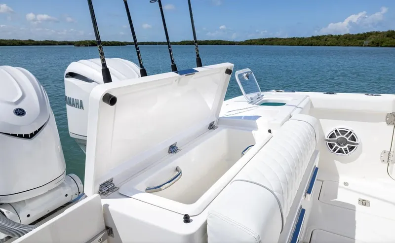 Slide: The Image of 2025 Pursuit OS 325 boat with open storage, Yamaha engines, and scenic water view. - 14