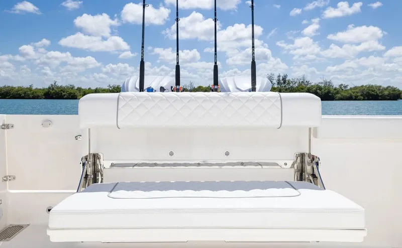 Slide: The Image of 2025 Pursuit OS 325 boat with fishing rods, white seating, and scenic water view. - 15