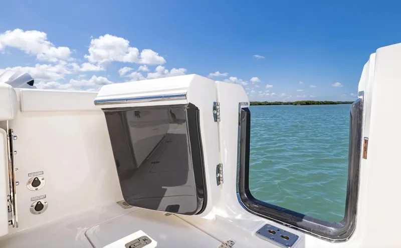 Slide: The Image of 2025 Pursuit OS 325 boat interior with ocean view and clear blue sky. - 18