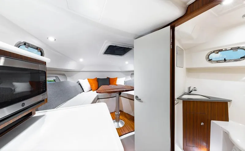 Slide: The Image of 2025 Pursuit OS 325 cabin interior with modern amenities and stylish design. - 20