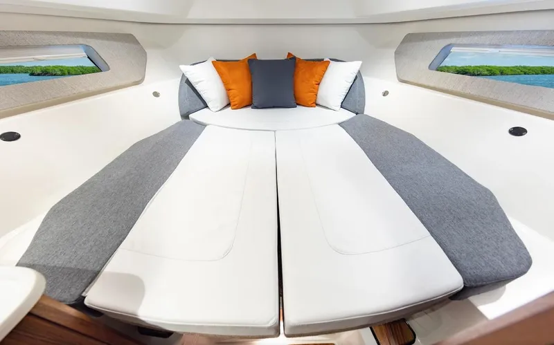 Slide: The Image of Luxurious interior cabin of 2025 Pursuit OS 325 boat with plush seating and cushions. - 21