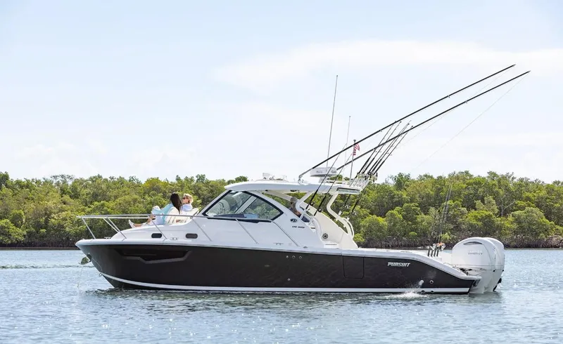 Slide: The Image of 2025 Pursuit OS 325 boat cruising on calm water with lush greenery in the background. - 3