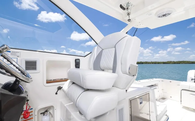 Slide: The Image of 2025 Pursuit OS 325 boat interior with luxurious seating and ocean view. - 6