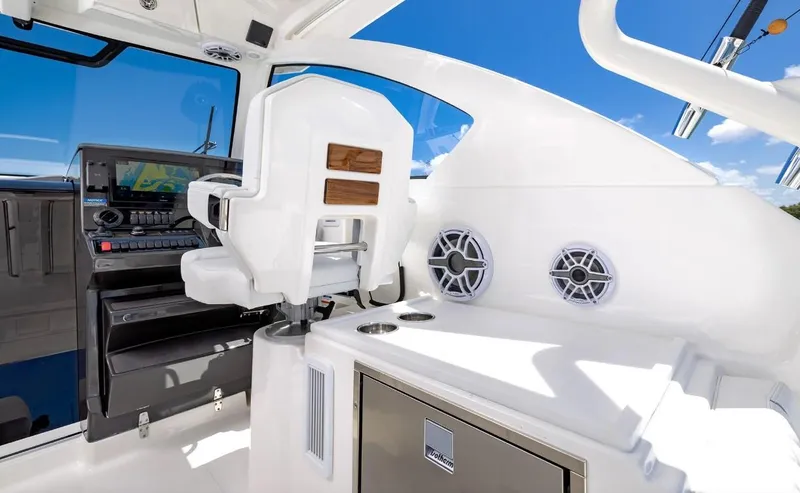 Slide: The Image of 2025 Pursuit OS 325 boat interior with captain's chair and control panel. - 8