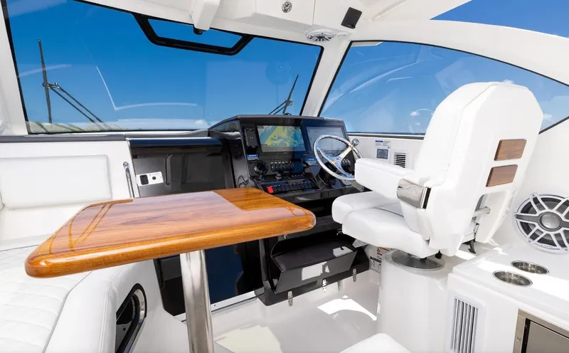 Slide: The Image of Interior of 2025 Pursuit OS 325 boat with modern helm and seating. - 9