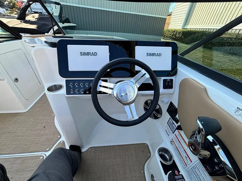 Slide: The Image of 2025 Sea Ray SDX 270 Outboard helm with Simrad displays and modern controls. - 12