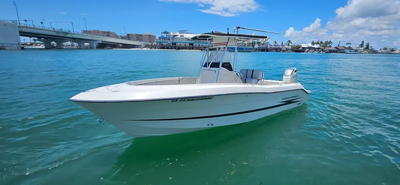 Slide: The Image of 2003 Hydra-Sports 2400 CC Vector boat on clear blue water near a bridge. - 0