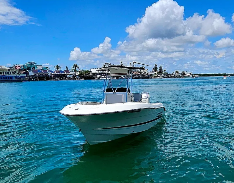 Slide: The Image of 2003 Hydra-Sports 2400 CC Vector boat on clear blue water under a sunny sky. - 1