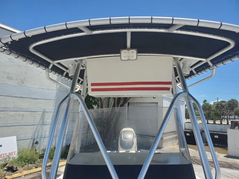 Slide: The Image of 2003 Hydra-Sports 2400 CC Vector boat with T-top and windshield, parked outdoors. - 16