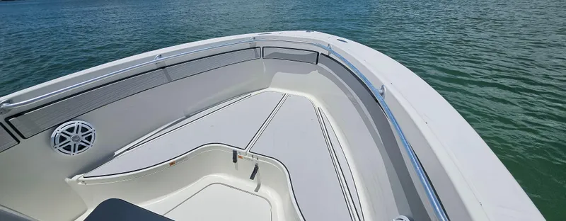 Slide: The Image of 2003 Hydra-Sports 2400 CC Vector boat bow, featuring sleek design on calm water. - 2