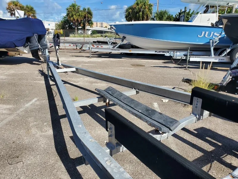 Slide: The Image of Boat trailer in a parking lot with a 2003 Hydra-Sports 2400 CC Vector nearby. - 28