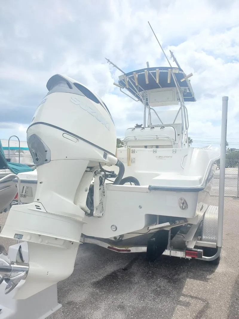 Slide: The Image of 2003 Hydra-Sports 2400 CC Vector boat with outboard motor, docked under cloudy sky. - 30