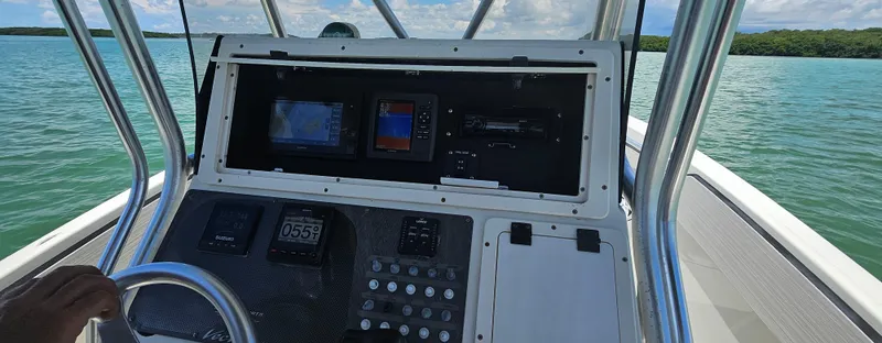 Slide: The Image of 2003 Hydra-Sports 2400 CC Vector boat dashboard with navigation equipment on open water. - 5