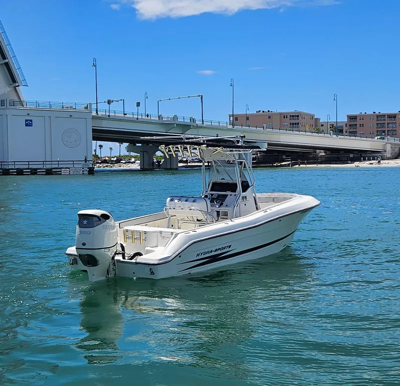 Slide: The Image of 2003 Hydra-Sports 2400 CC Vector boat on water near a bridge under a clear blue sky. - 9
