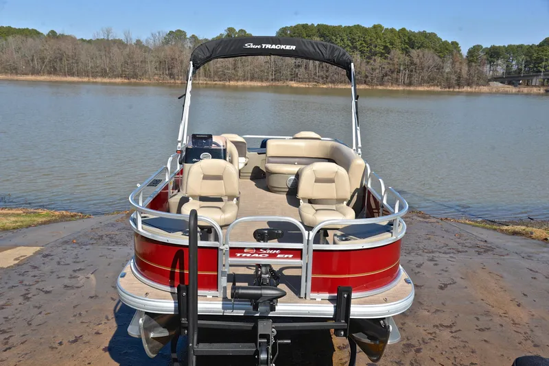 Slide: The Image of 2022 Sun Tracker BASS BUGGY 18 pontoon boat on a lakefront. - 17