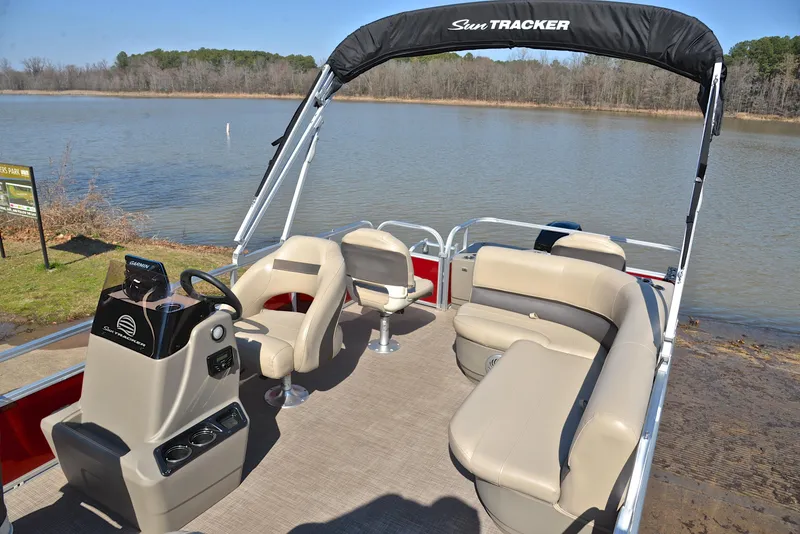 Slide: The Image of 2022 Sun Tracker BASS BUGGY 18 pontoon boat on a serene lake. - 21