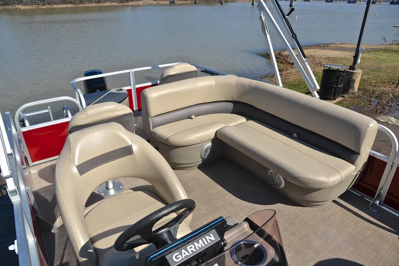 Slide: The Image of 2022 Sun Tracker BASS BUGGY 18 pontoon boat interior with beige seating and Garmin navigation. - 23