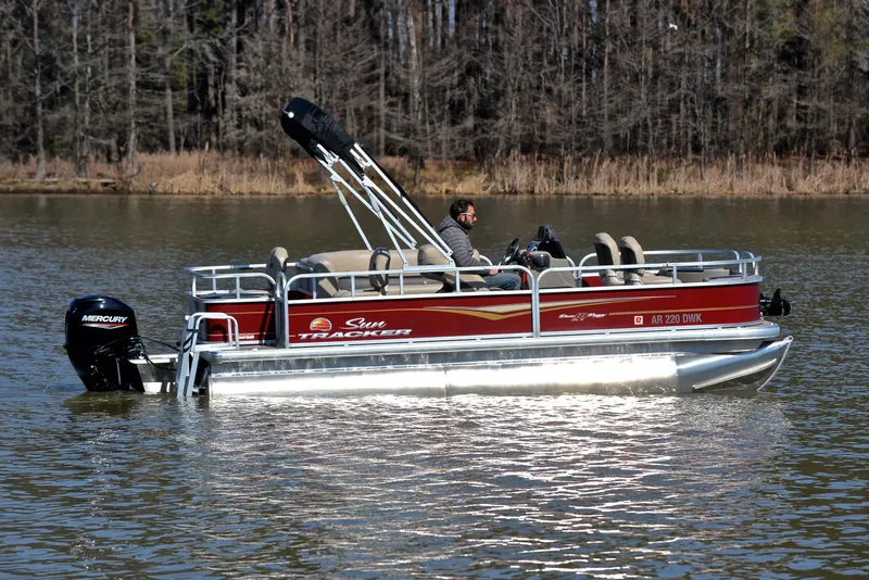 Slide: The Image of 2022 Sun Tracker BASS BUGGY 18 pontoon boat on a calm lake. - 6