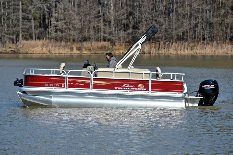 Slide: The Image of 2022 Sun Tracker BASS BUGGY 18 pontoon boat on a calm lake. - 8