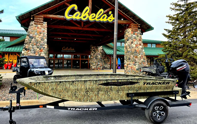 The Image of 2025 Tracker Grizzly 1650 T Prairie Wings Edition boat at Cabela's entrance. - 0