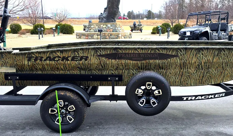 Slide: The Image of 2025 Tracker Grizzly 1650 T Prairie Wings Edition boat on trailer, camo design. - 5