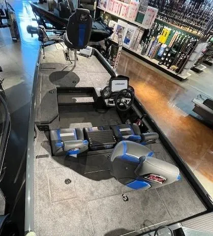 Slide: The Image of 2025 Ranger RT178 boat interior with seating and steering console in a showroom. - 3