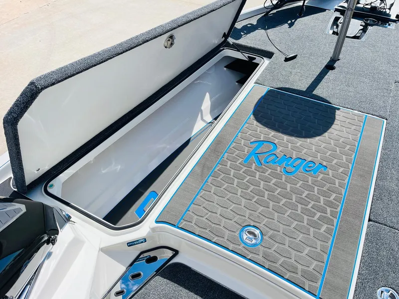 Slide: The Image of 2025 Ranger Z521R Cup-Equipped boat with open storage compartment and branded deck mat. - 20
