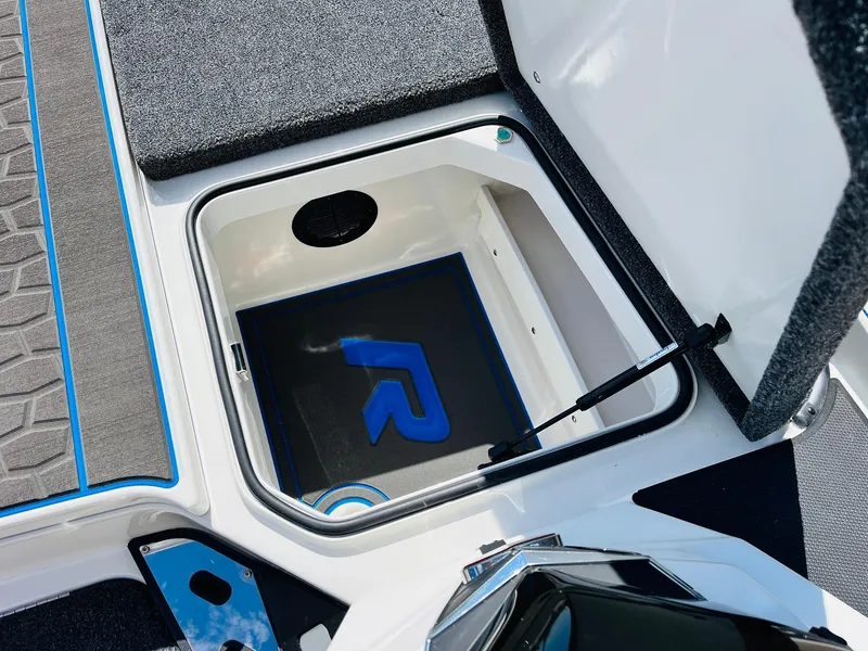 Slide: The Image of 2025 Ranger Z521R Cup-Equipped boat storage compartment with blue accents. - 28