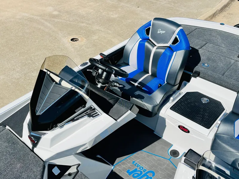 Slide: The Image of 2025 Ranger Z521R Cup-Equipped boat cockpit with blue and gray seating. - 34
