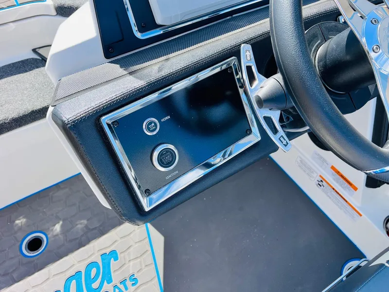 Slide: The Image of 2025 Ranger Z521R Cup-Equipped boat dashboard with steering wheel and control panel. - 42