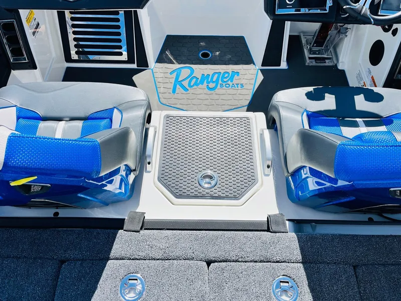 Slide: The Image of 2025 Ranger Z521R Cup-Equipped boat interior with blue seats and branded flooring. - 44