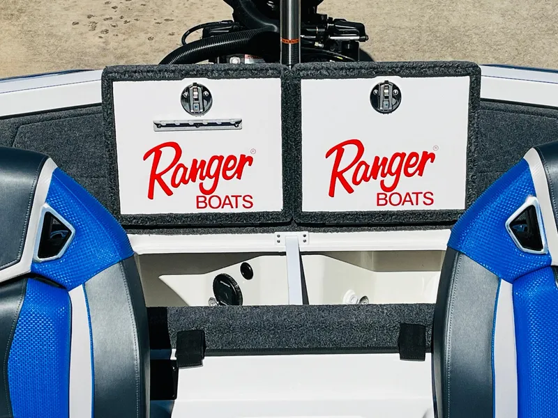 Slide: The Image of 2025 Ranger Z521R Cup-Equipped boat interior with blue seats and storage compartments. - 48