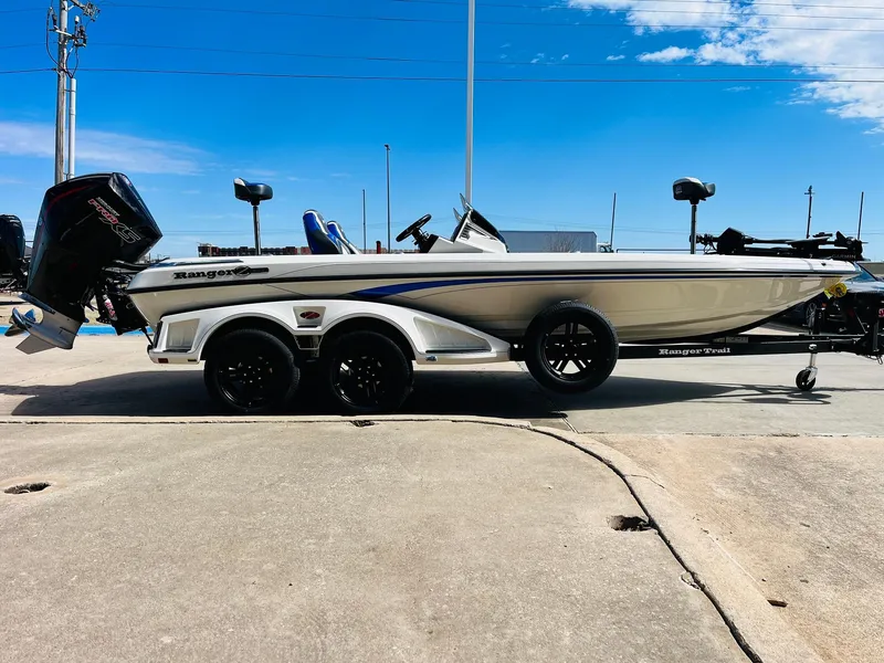 Slide: The Image of 2025 Ranger Z521R Cup-Equipped boat on trailer, side view, under clear blue sky. - 6