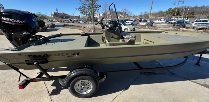 Slide: The Image of 2025 Tracker Grizzly 1860 CC boat on trailer, parked outdoors. - 3