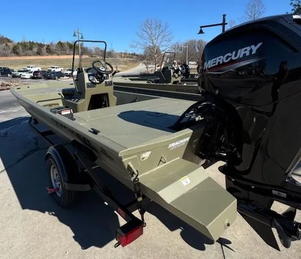 Slide: The Image of 2025 Tracker Grizzly 1860 CC boat with Mercury engine on trailer, outdoors. - 6