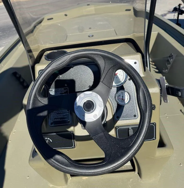 Slide: The Image of Steering console of 2025 Tracker Grizzly 1860 CC boat with gauges and controls. - 9